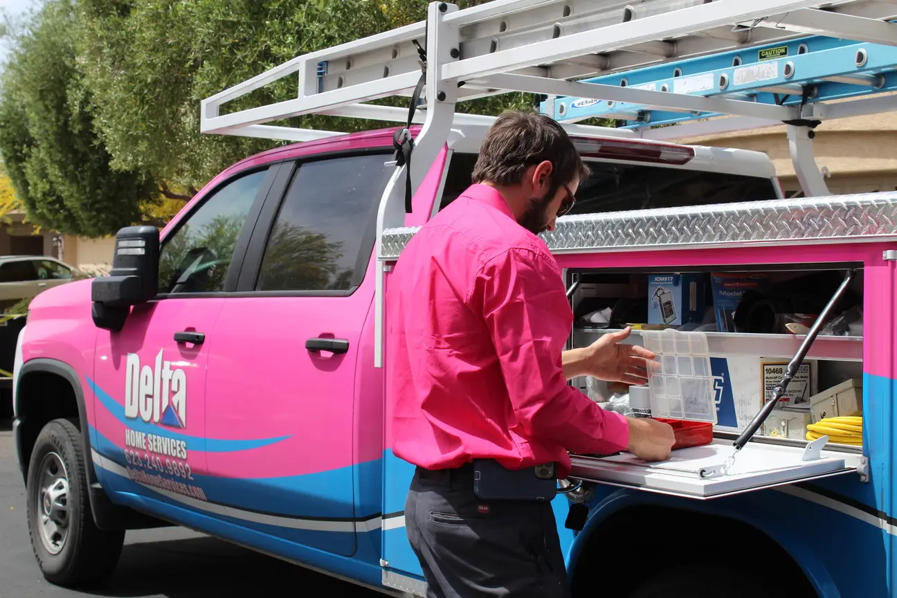 Delta Home Services technician preparing equipment at service truck