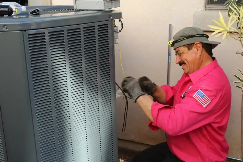 Technician performing AC repair maintenance