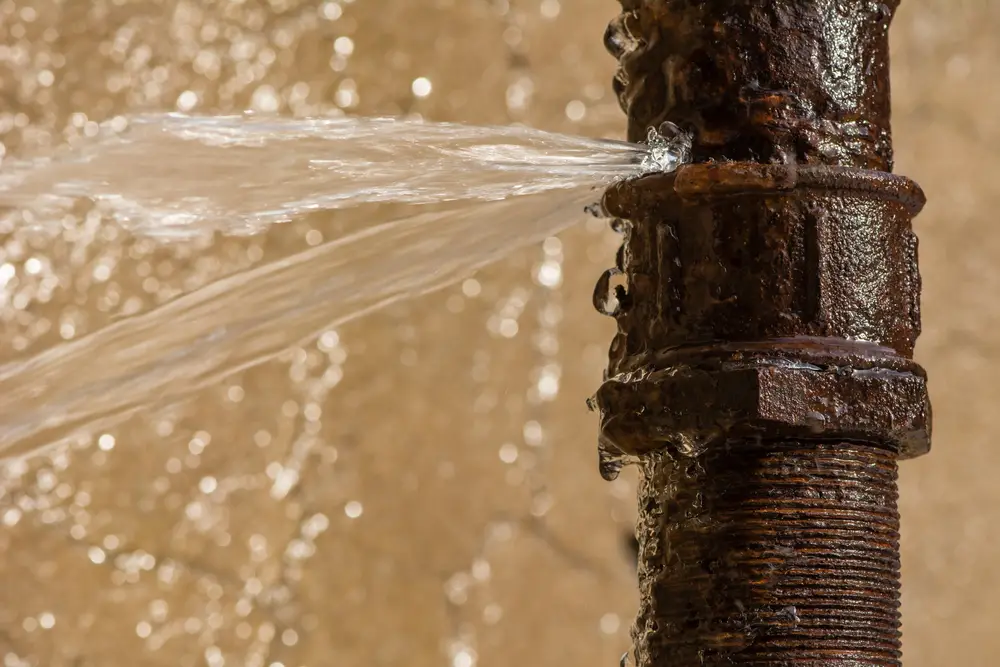 Burst pipe spraying water after freezing